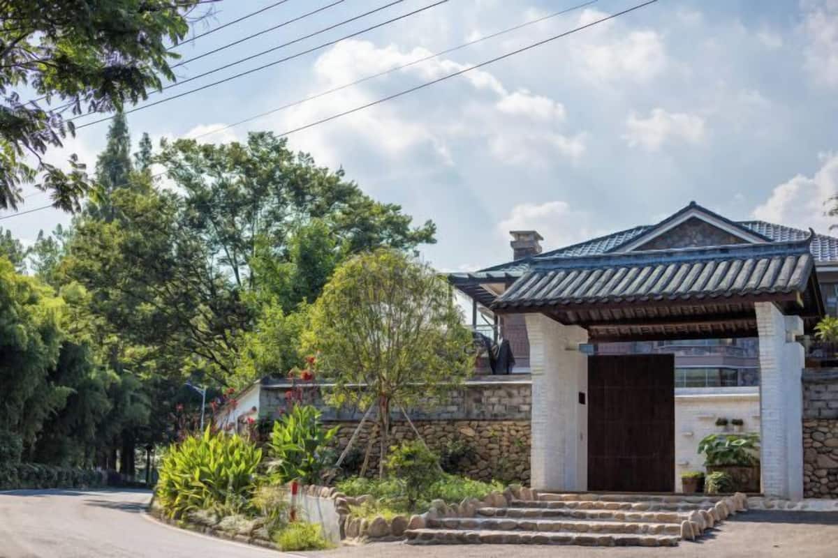 A traditional building with a tiled roof, stone walls, and a wooden door.