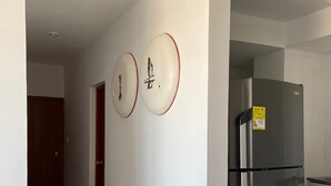 A modern kitchen with a stainless steel refrigerator, a wooden door, and a tiled floor. - 3TP-27 APARTAMENTO DE 3 HABITACIONES (Cartagena)