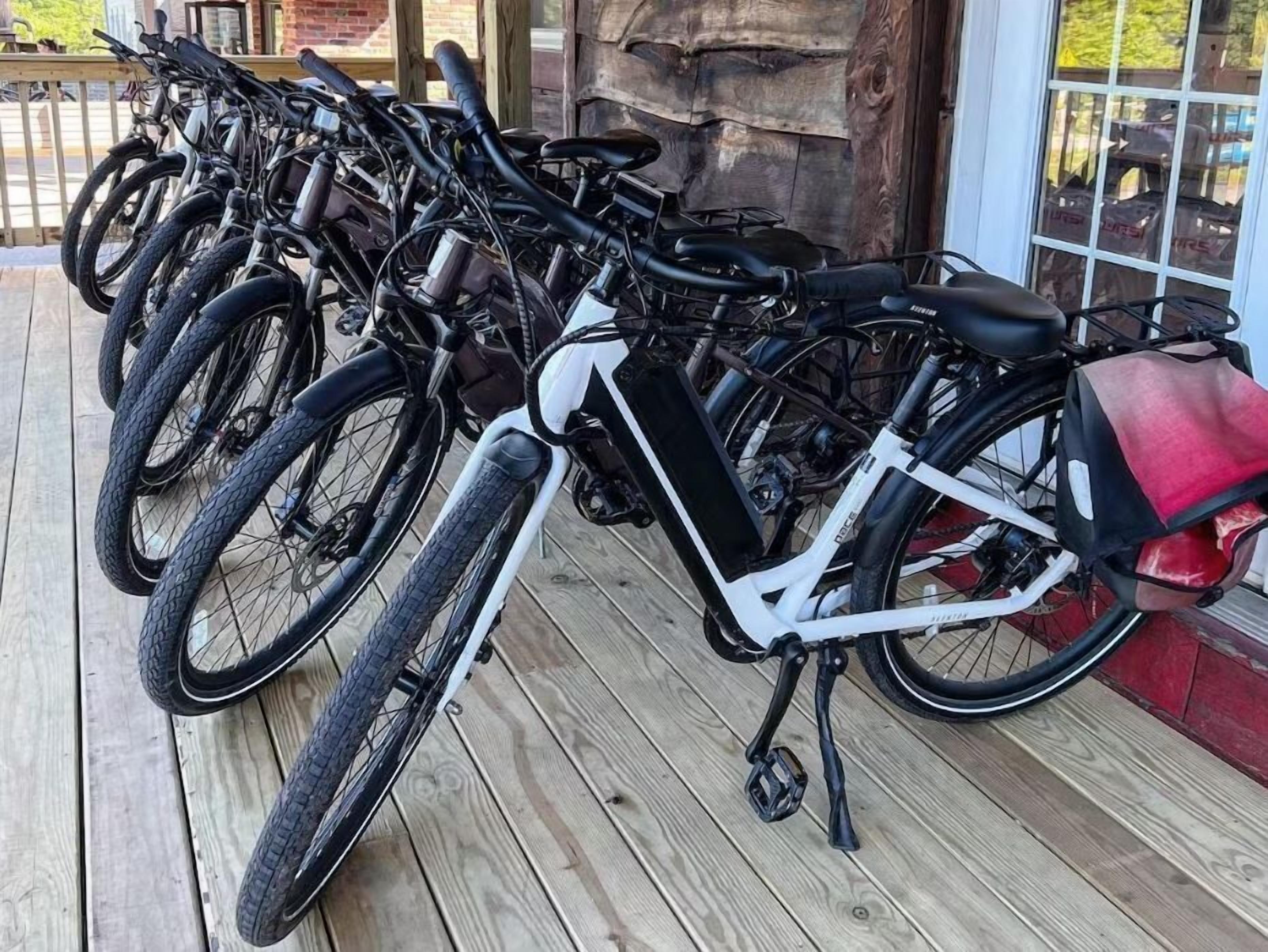 A row of bicycles parked on a wooden deck.