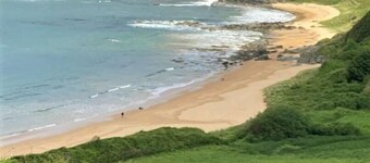 Private location overlooking lush glen. Short walk to beautiful secluded beach.