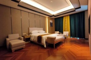 A hotel room with a bed, two bedside tables, a chair, a nightstand, and a window with curtains.