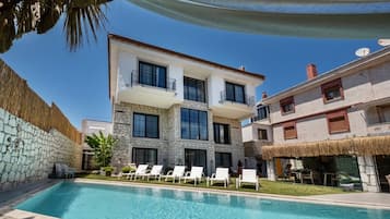 Guests can enjoy a refreshing swim in the pool surrounded by comfortable lounge chairs.