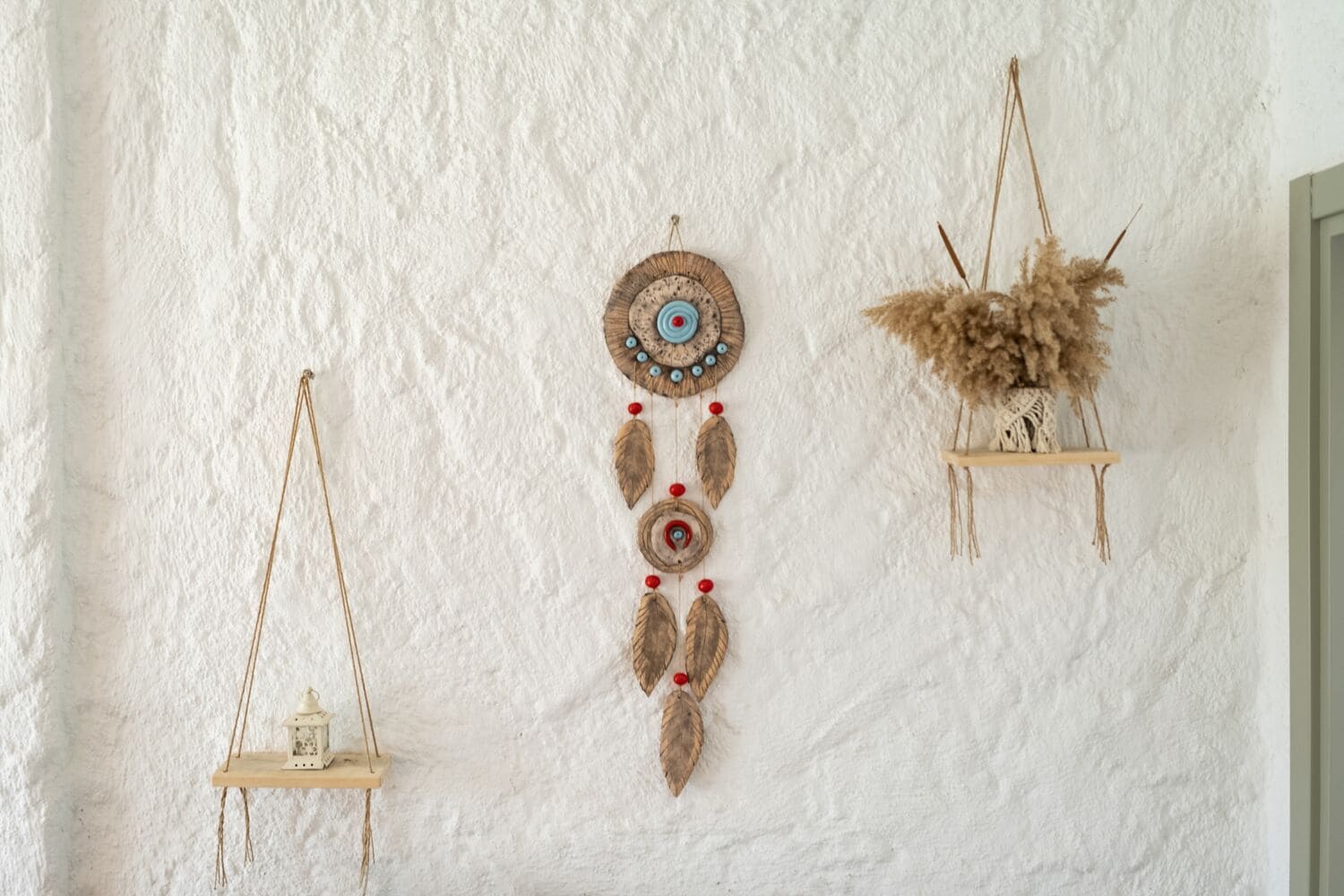 Three wall-mounted dreamcatchers of varying designs.