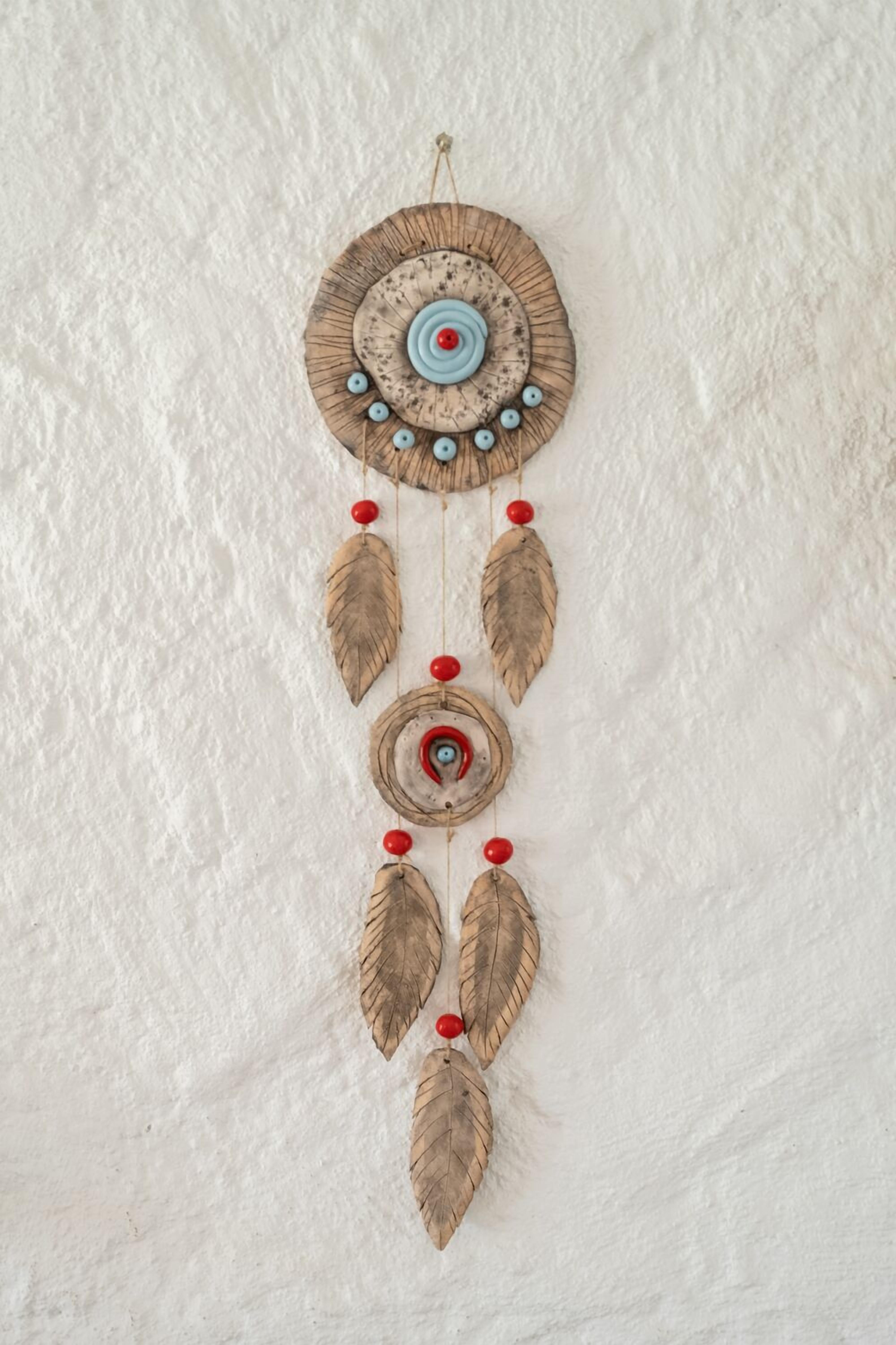 A dreamcatcher with concentric circles and feathers.