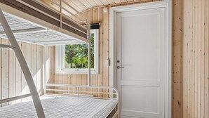 A bunk bed with a window, a white door, and wooden walls. - Awesome home in Gilleleje with WiFi (Gilleleje)