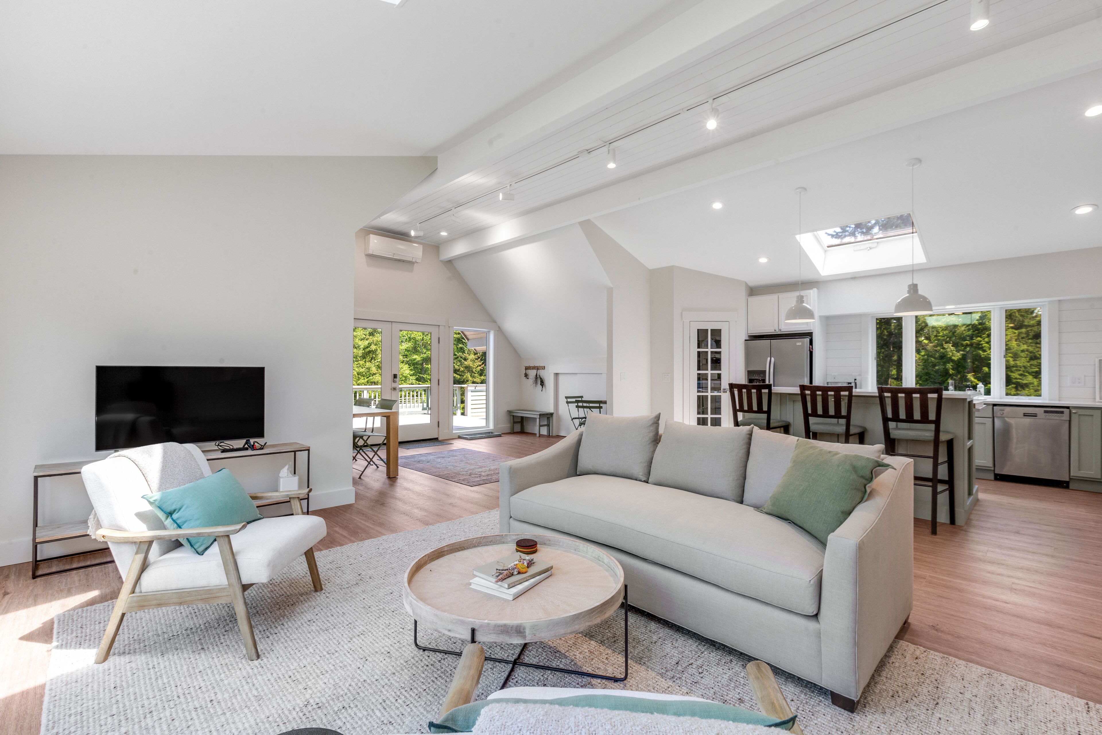 New construction - upper-level home with expansive deck & orchard views