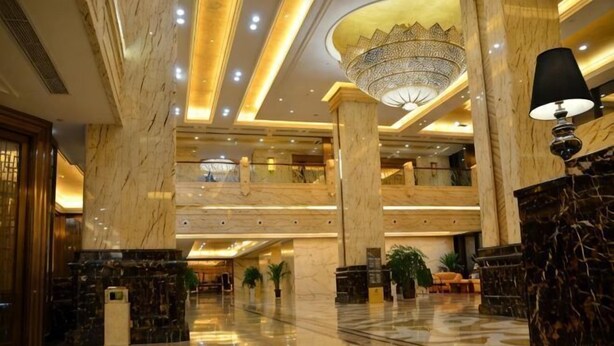 A spacious lobby with marble flooring, a chandelier, and a high ceiling. - Danling Jinjiang Hotel (Danleng)