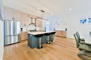 Enjoy meals in the kitchen with a central island, dining area, and modern appliances.