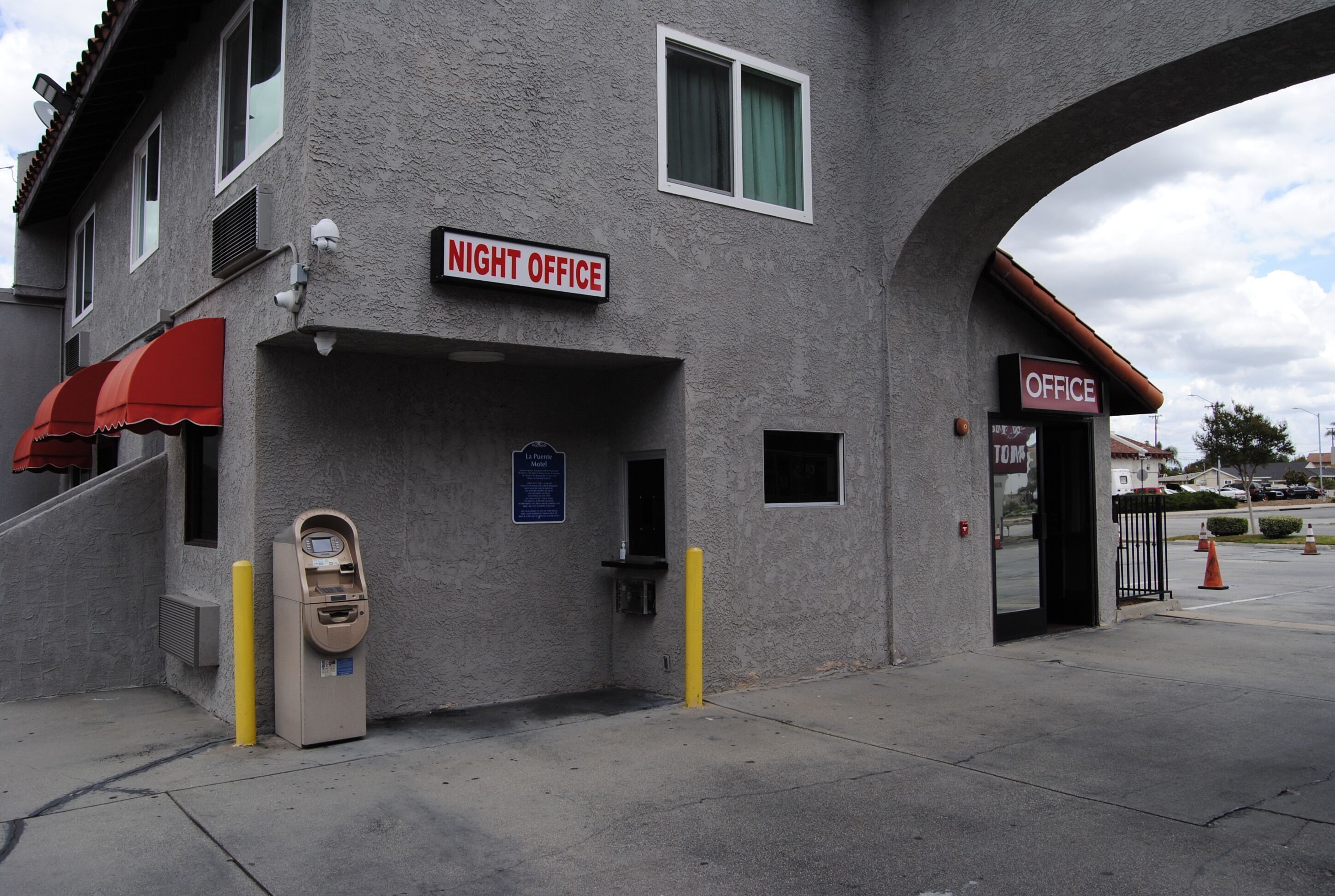 A building with a sign reading "NIGHT OFFICE" and another sign reading "OFFICE".