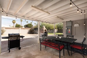Enjoy al fresco dining on the patio, where a barbecue grill and table with comfortable seating await.