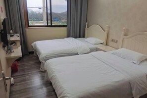 A hotel room with two beds, a desk with a computer, and a window with a view. - Xinchang Yunqi Small Building House (Xinchang)