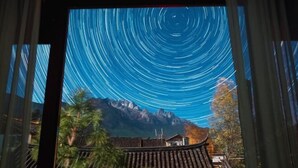 A room with a view of mountains and traditional architecture. - Baisha No. 66 Post Station (Yulong)