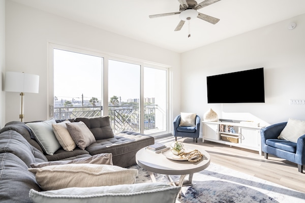 Relax and unwind in this super comfy couch with lots of pillows and soft rug.