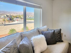 Relax in this stylish living room with a large window offering a view of the surrounding area.