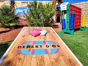 Playful games and activities await at this vibrant public space, featuring a board game table and a colorful play structure.