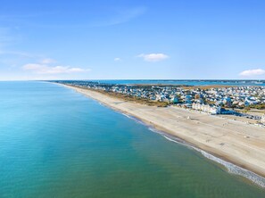 An aerial view of a coastal town with a beach, houses, and a clear sky. - 5 Star Reviews! Luxury Home, Pool, Steps from Ocean,Sleeps 7, Shops,Restaurants (Atlantic Beach)