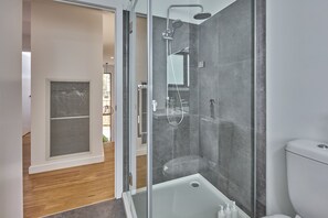 Enjoy a refreshing shower or soak in the bathtub in this minimalist bathroom.