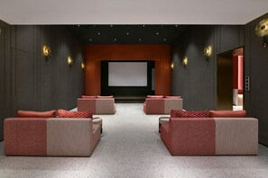 A modern home theater with a large screen, plush seating, and ambient lighting. - Blossom Hill Hotel Nanjing Bojin (Nanjing)