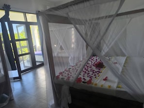 Triple Room - Garden View | Minibar, in-room safe, desk, laptop workspace