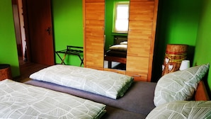 A room with three beds, a wooden wardrobe, a window, and a chair. - Apartment 'Villingen' with Balcony and Wi-Fi (Villingen-Schwenningen)