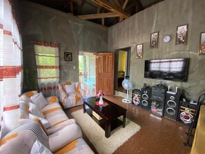 Relax in this stylish living room with a sofa set, flat-screen TV, and sound system.