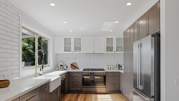 A modern kitchen with white subway tiles, stainless steel appliances, and wooden flooring. - Renovated open planned living sun drenched house in Cape Woolamai (Cape Woolamai)