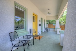 A covered porch with chairs, a door, and a view of the outdoors. - Remodeled Gem 5 minutes to UA (Tucson)