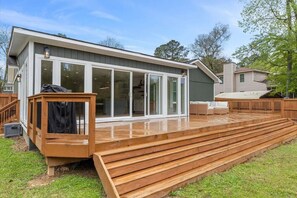 Enjoy outdoor dining and relaxation on the spacious deck with seating and a covered area.
