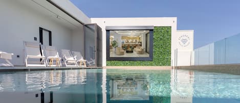 Indoor pool, seasonal outdoor pool, pool umbrellas, pool loungers
