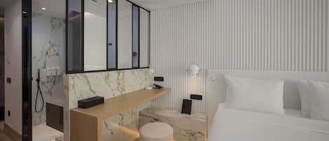 A modern bedroom with a large bed, a marble accent wall, a wooden console table, and a round ottoman.