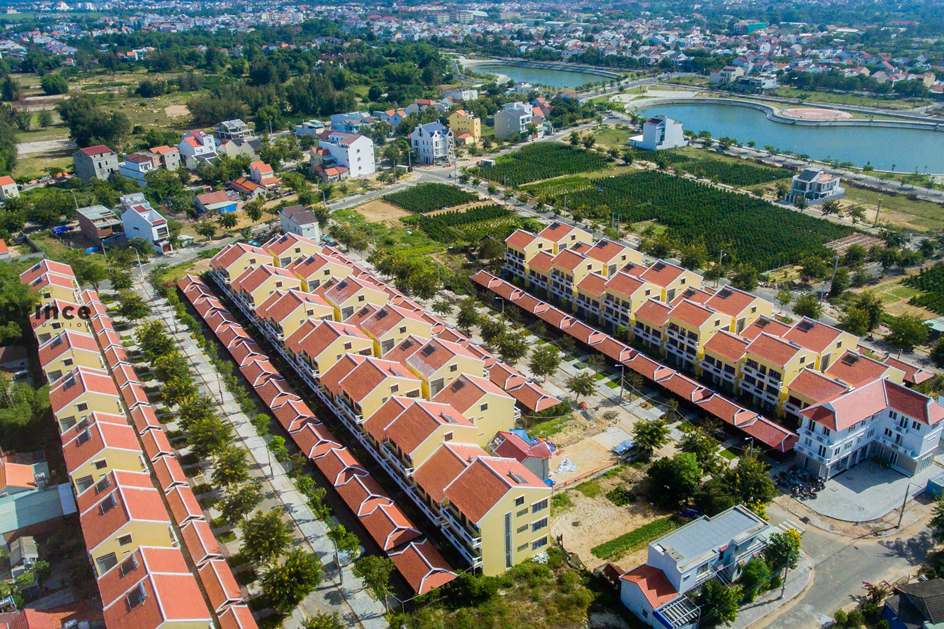 A residential area with multiple apartment buildings, a river, and a bridge.
