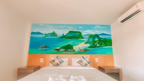 A hotel room with a bed, a painting of a tropical landscape, and a wooden headboard. - Chanpailin Omarzaa (Krabi)