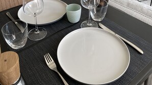 A modern kitchen with a herringbone tile backsplash, stainless steel appliances, and light blue cabinets. - New vacation cottage in the idyllic Ilz valley. 5 minutes to Passau (Salzweg)