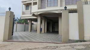 A multi-story residential building with a checkered entrance and balconies. - Magvaris Comfort Inn (Shillong)
