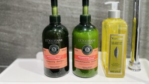 Three bottles of L'OCCITANE hair care products on a bathroom counter. - Amazing river view! best place to travel Seoul :) (서울특별시)