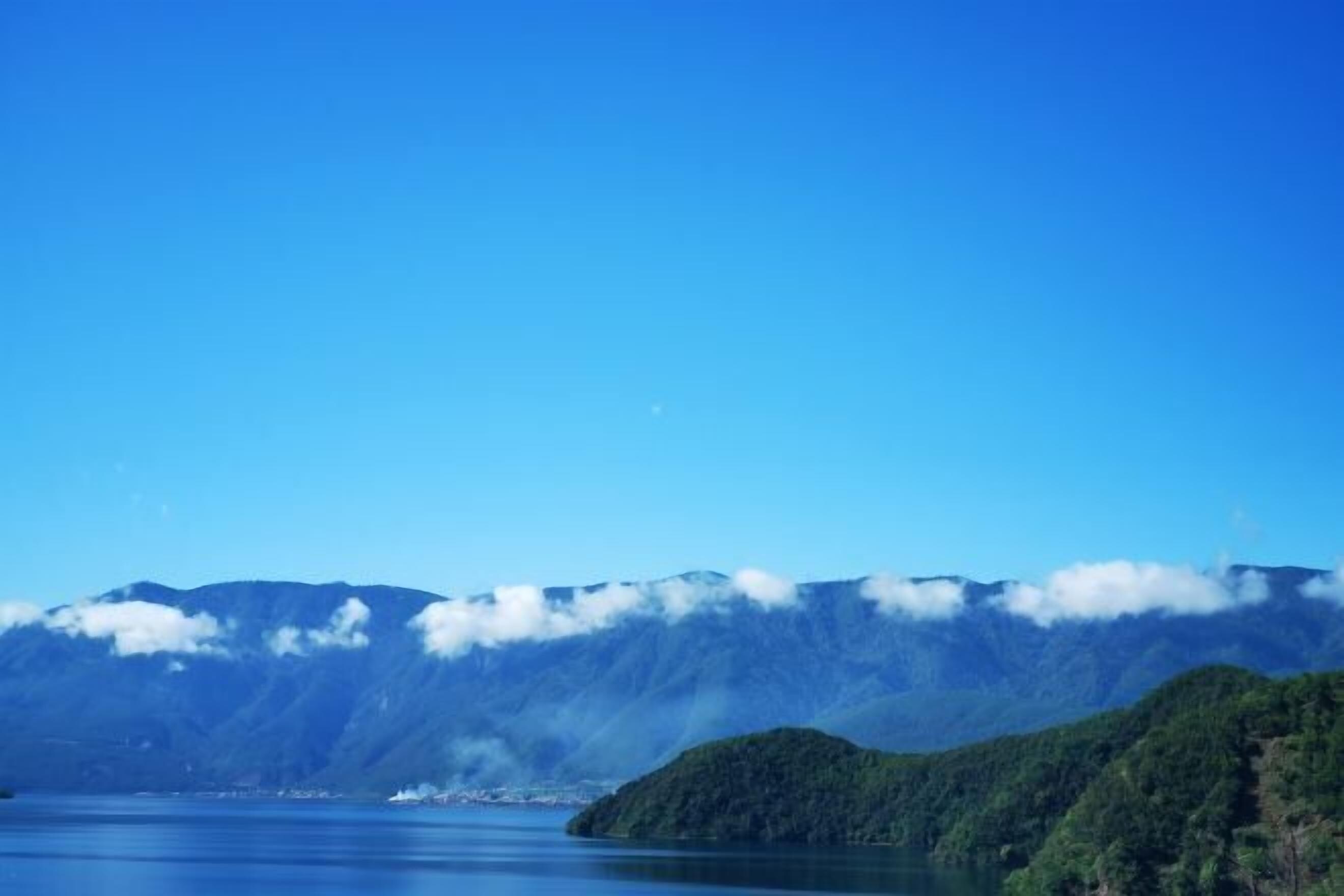A mountain landscape with a lake and a small island.