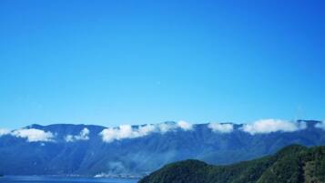 A mountain landscape with a lake and a small island.