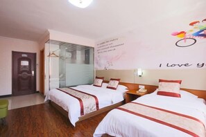 A hotel room with two beds, a wooden floor, a glass door, and a wall with a motivational quote. - Dunhua Service Building Hotel (Dunhua)