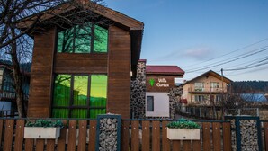 A two-story wooden building with a sign reading "Villa Garden."