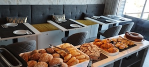 Enjoy a delicious breakfast in this inviting room, complete with a beautifully set table and a variety of sweet treats.