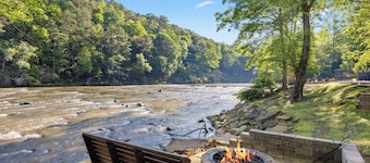 Ideal for large families, this riverfront gem boasts a dock, firepit, hot tub, basketball court, and a pool table for endless fun. Pet Friendly and WiFi
