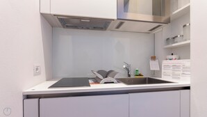 A modern kitchen with a stainless steel sink, a built-in oven, and a microwave. - Italianway Easy - Vincenzo Monti 32 (Milan)