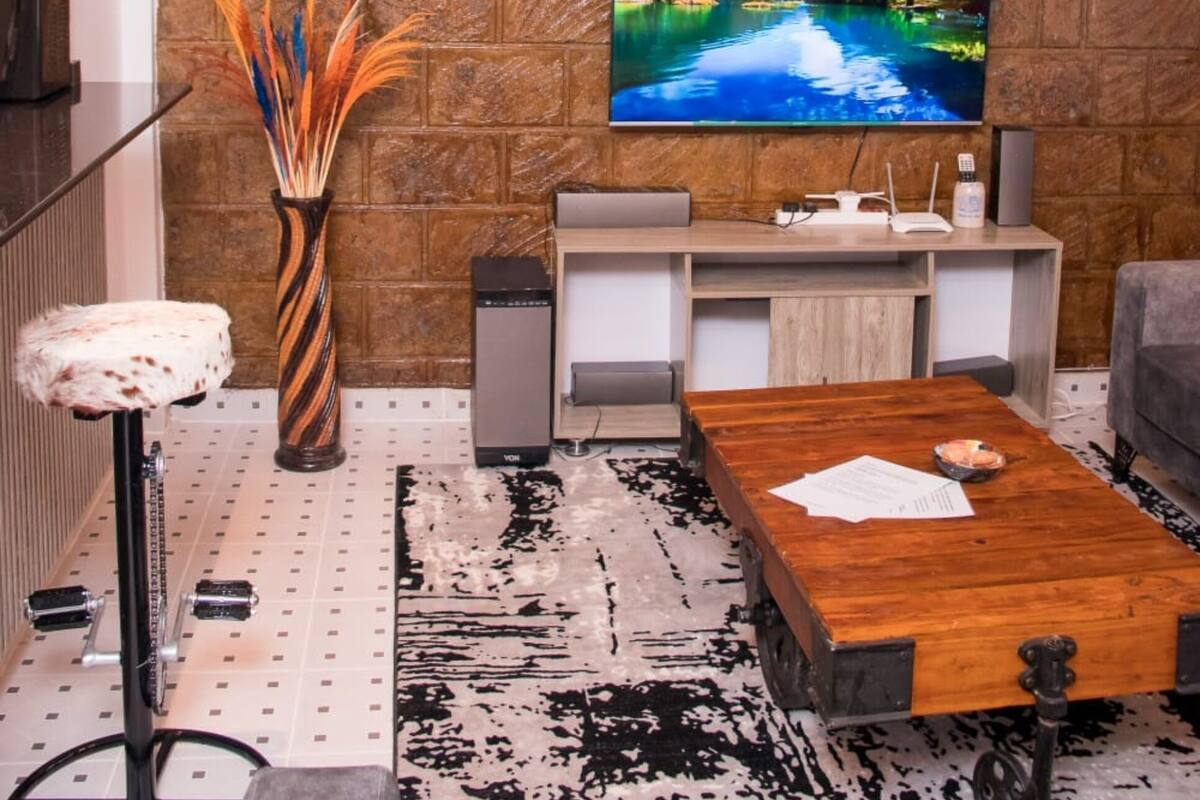 Deluxe Apartment, 1 Bedroom | Living area | 24-inch flat-screen TV with digital channels, TV