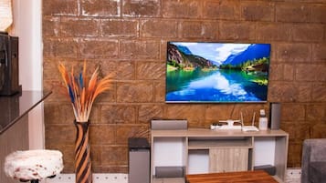 Deluxe Apartment, 1 Bedroom | Living area | 24-inch flat-screen TV with digital channels, TV