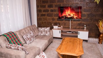 Comfort Apartment | Living area | 24-inch flat-screen TV with digital channels, TV