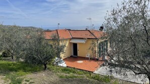 A small, yellow building with a red-tiled roof, surrounded by olive trees and a clear sky. - Apartment Aurora by Interhome (Costarainera)