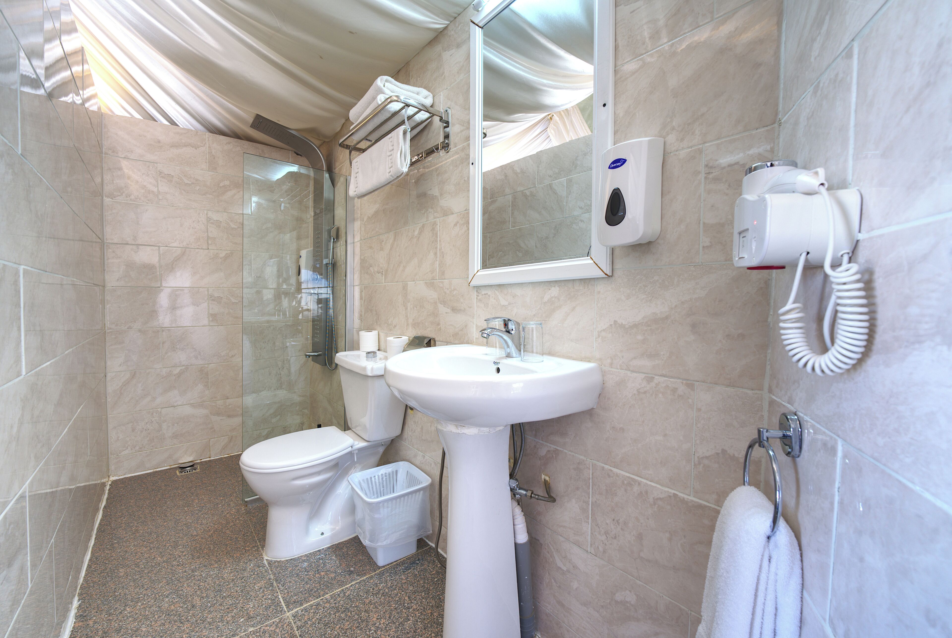 A bathroom with a sink, toilet, and shower.