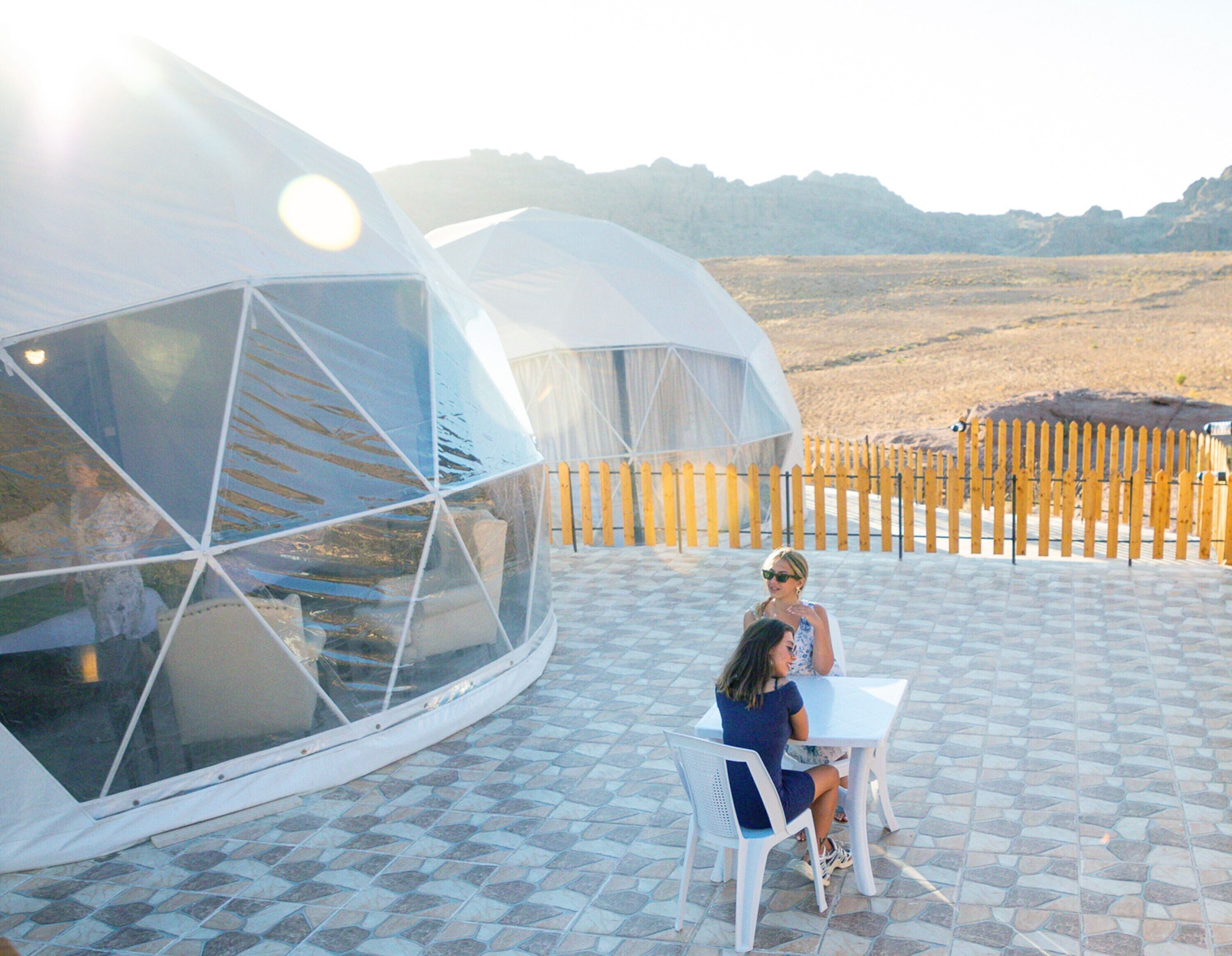 A modern, dome-shaped structure with a tiled patio area.