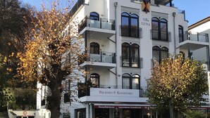A multi-story building with balconies, a sign reading "Villa LENA," and outdoor seating with tables and chairs. - SELLIN-Wilhelmstraße, mod. apartment in top location, 200 m to the beach / pier, terrace (Sellin)