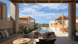 A covered outdoor area with a pool, seating, and plants. - Cicada Theros Suite, with Private Pool, Gym, BBQ,  Beach & 5*Hotel Access
 (Heraklion)